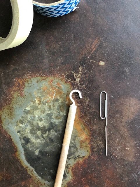 Partially open paper clip to make the button hook