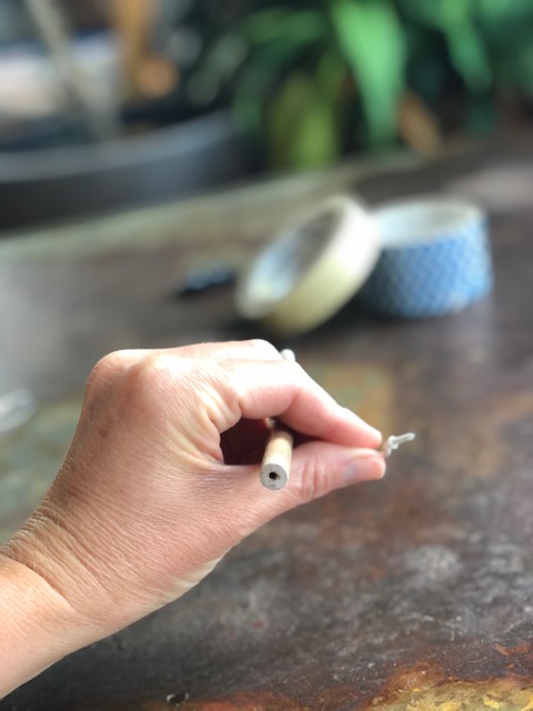 Screw in the small hook into the dowel rod