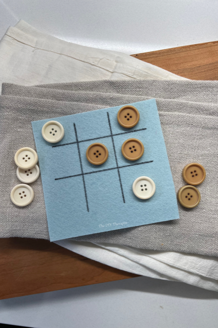 DIY fine motor game: Button Tic-Tac-Toe to practice pincer grasp and finger isolation.