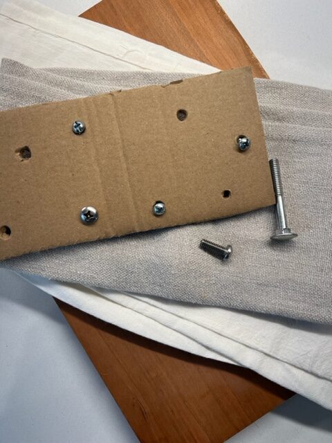 Fine motor strengthening activity: Using nuts and bolts to improve pincer grasp and bilateral coordination.