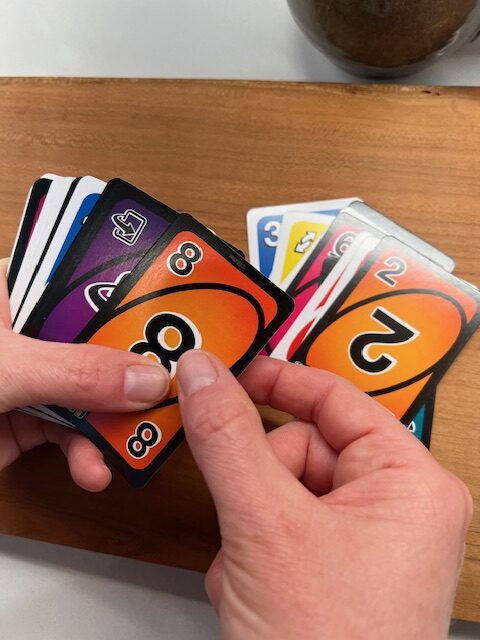 Fine motor shifting exercise: Using playing cards to practice repositioning objects within one hand.