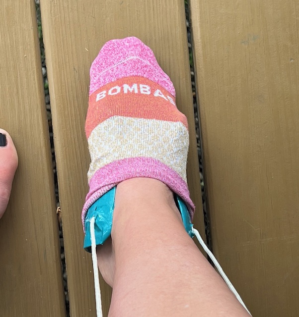 Using a DIY small-sized sock aid to put on socks independently.