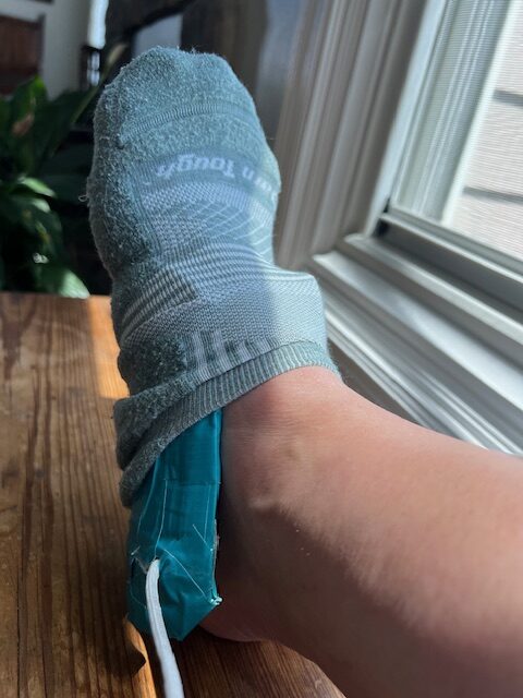 Using a DIY small-sized sock aid to put on socks independently.