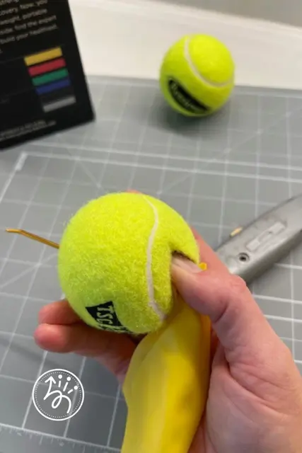 How to add tennis balls to sensory bouncy bands for increased tactile and proprioceptive input.