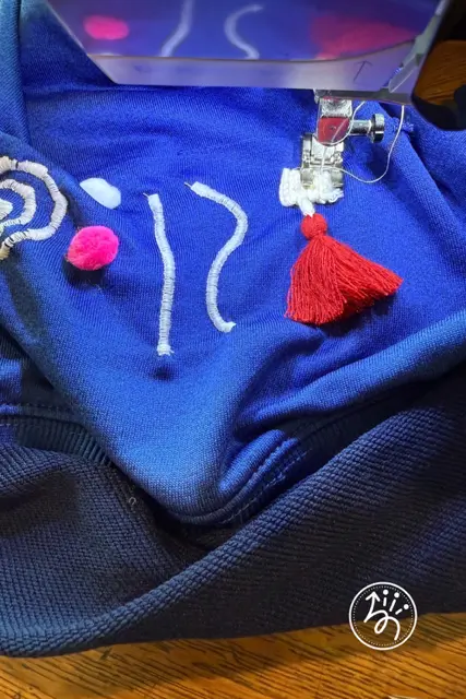 DIY sensory fidget hoodie, step #3 in step-by-step tutorial (sewing on fidgets)